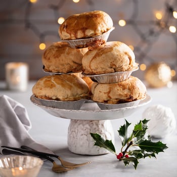 A stack of Christmas Pies on a cake stand